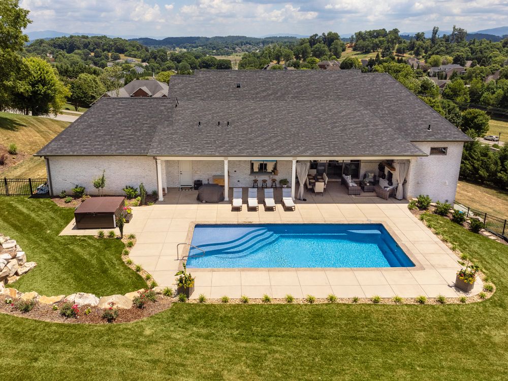 rectangular shaped fiberglass pool in sloped Tennessee backyard