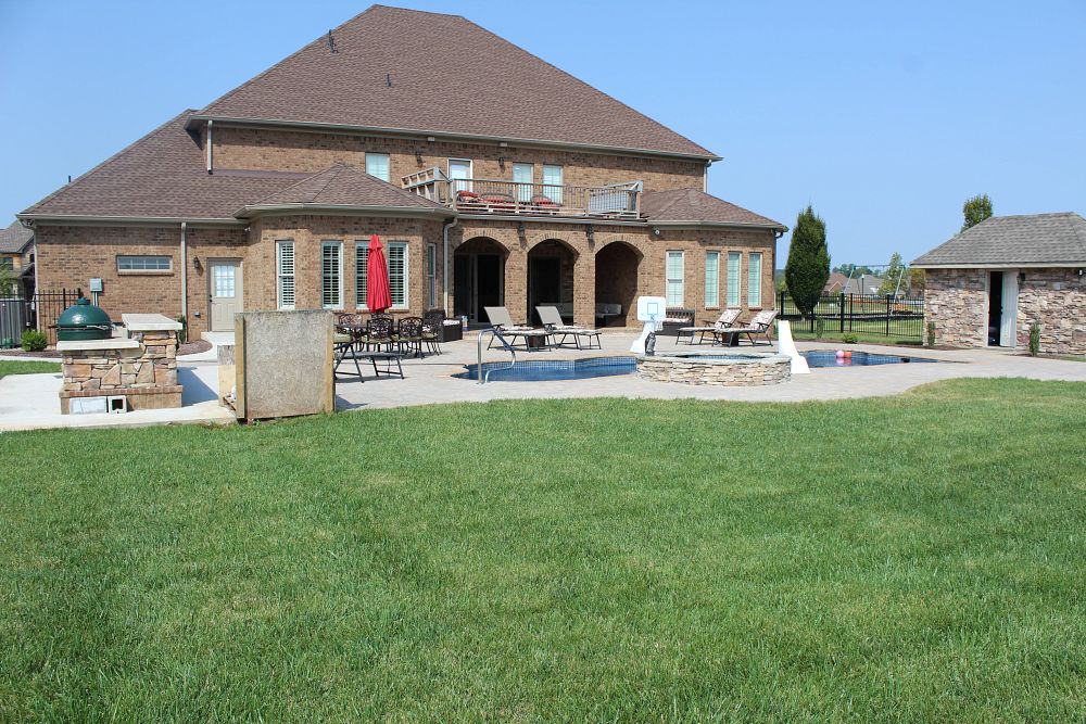 modern pool with large deck and grill