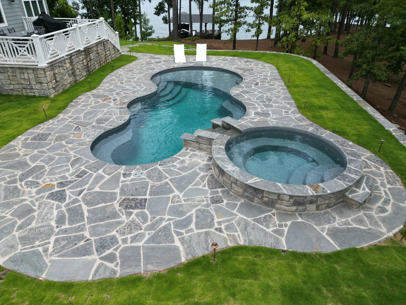 fiberglass pool and spa with custom water feature in southern backyard
