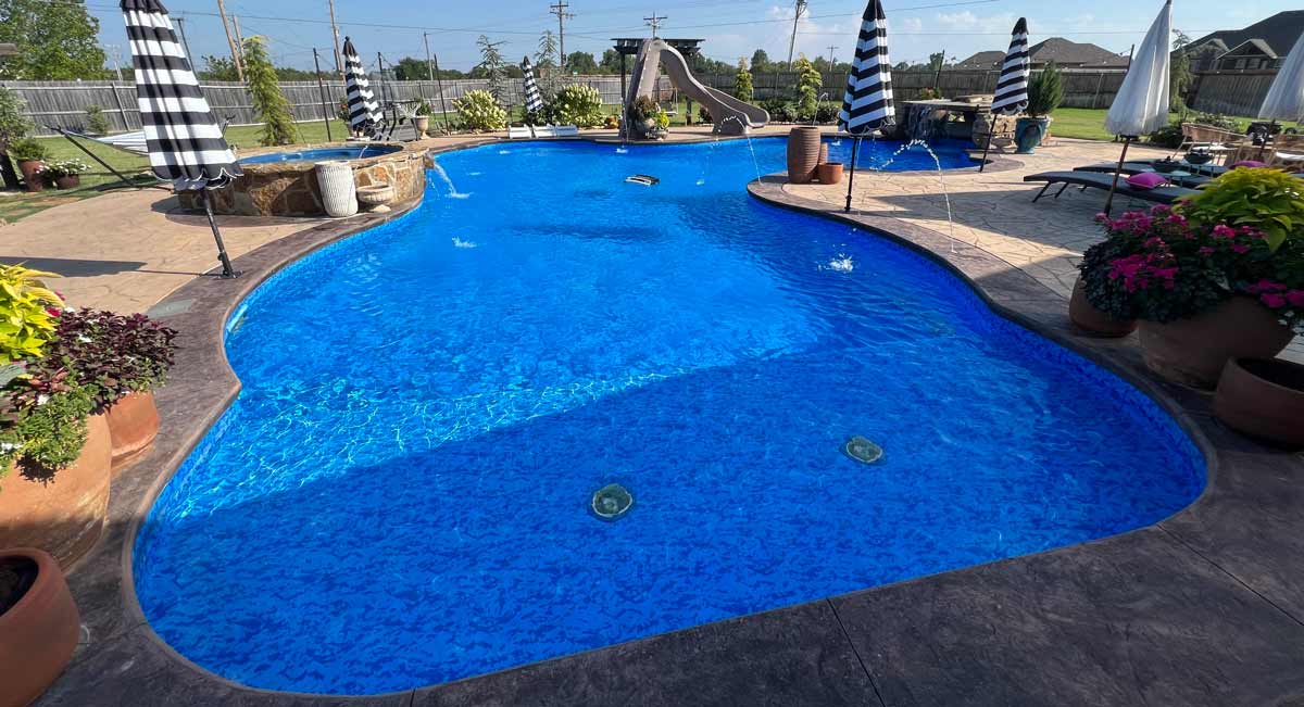 large vinyl liner pool with custom water feature in Oklahoma backyard