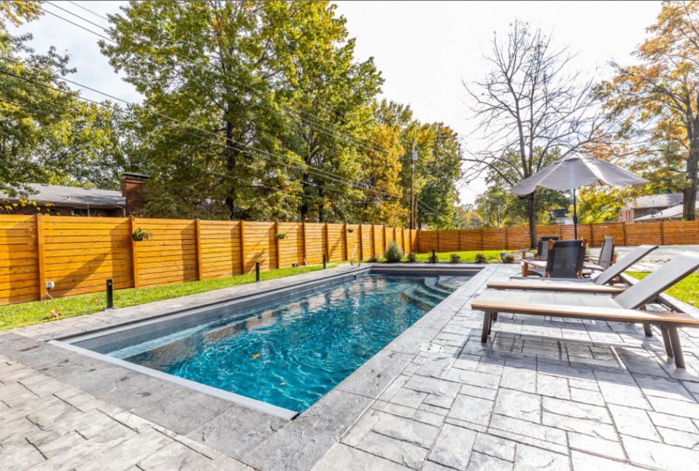 compact fiberglass pool in small backyard