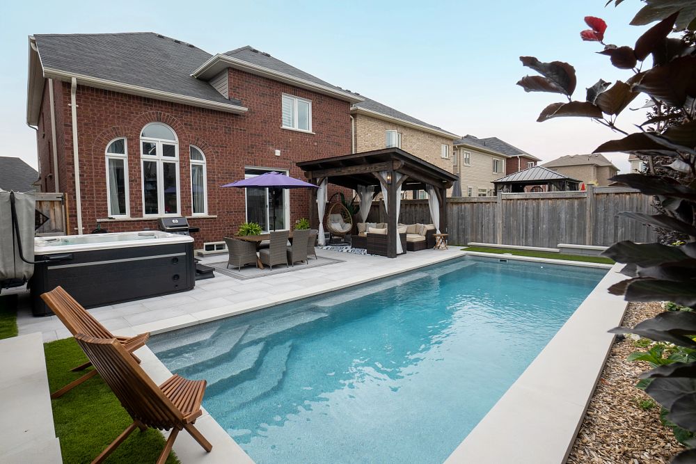 Fiberglass Pool | Photo courtesy of Scenic View Landscaping Inc compact fibreglass pool in small Canadian backyard