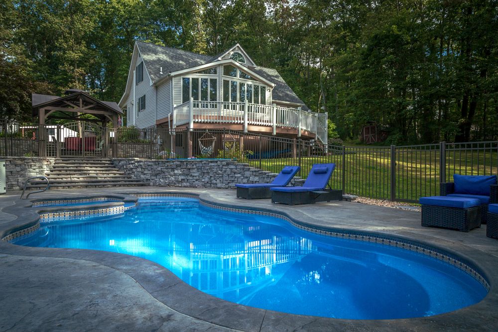 spacious fiberglass pool in large backyard