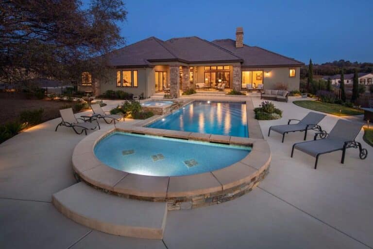 fiberglass pool with LED lights, spa, tanning ledge, and custom coping