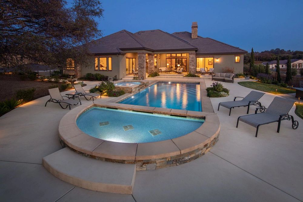 fiberglass pool with LED lights, spa, tanning ledge, and custom coping