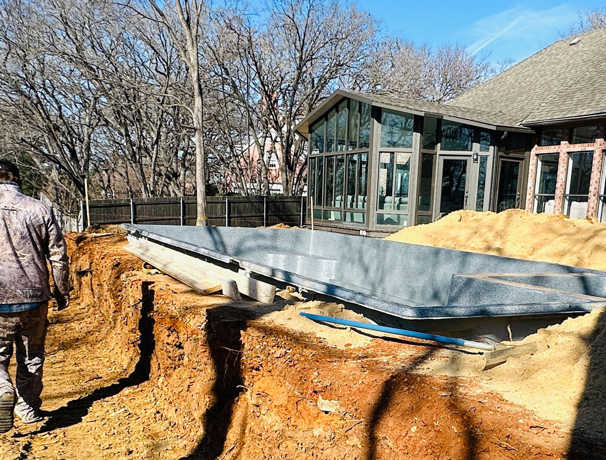new fiberglass pool being installed in Texas backyard